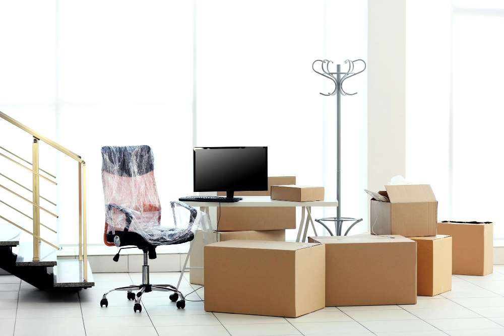 Office equipment and chairs being moved into van
